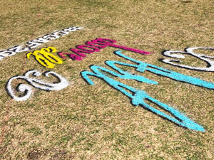 Spray chalk Art Above All 3D on grass skew