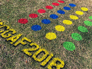Spray chalk Twister game on grass