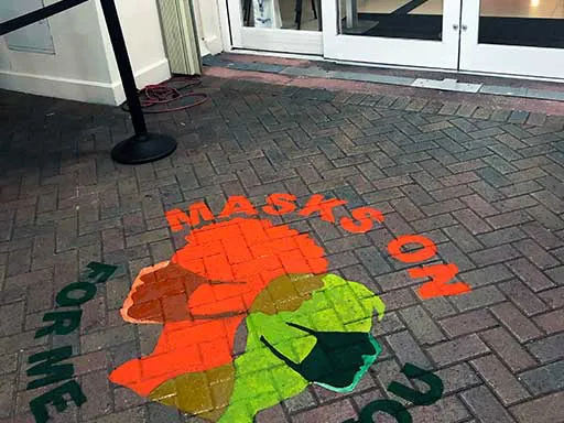 Angle view of Masks On For You For Me hospital pavement art