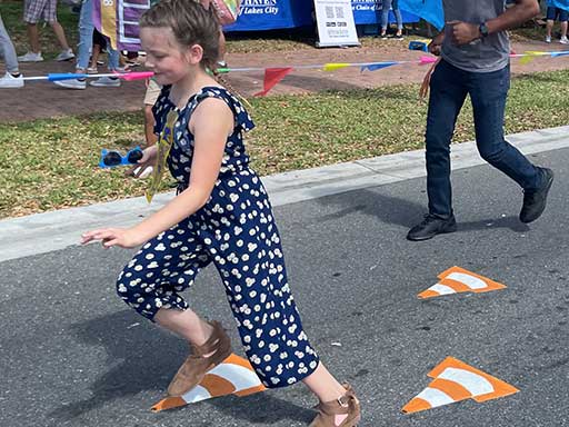 Children playing on anamorphic 3D interactive obstacle fitness course