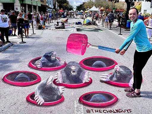 Posing with 3D chalk art interactive Whac-a-Mole