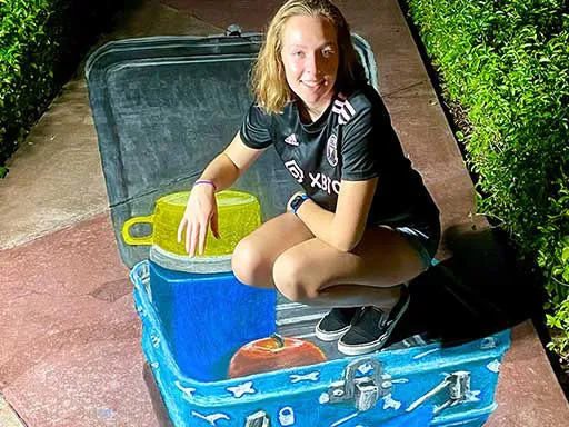 Posing with 3D chalk art of vintage retro metal lunchbox