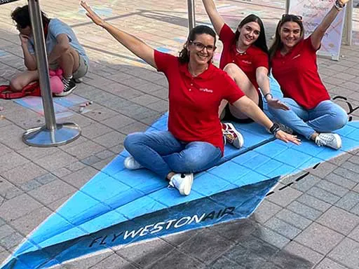 Posing on 3D chalk art of paper airplane