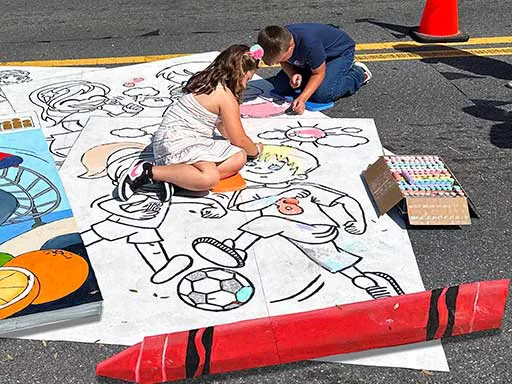 Posing with painted image of Health-themed interactive coloring book