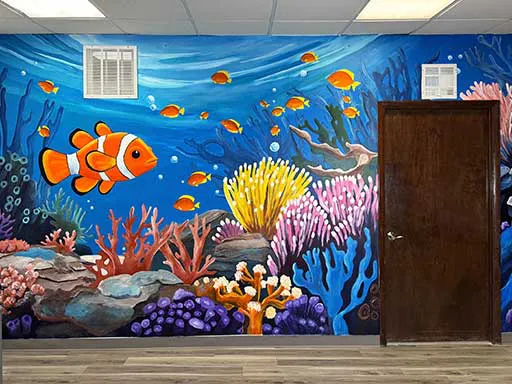 Angle view of wall mural featuring underwater coral and clownfish