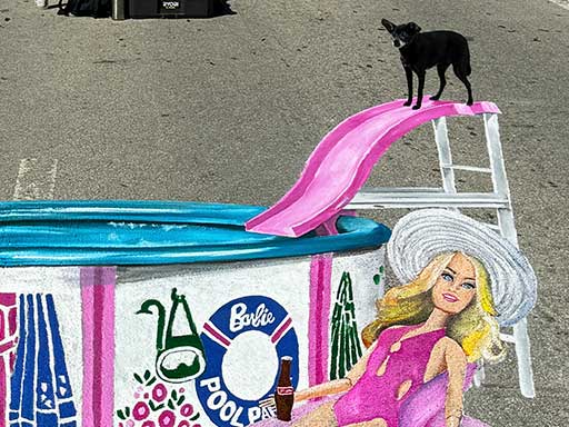 Dog posing with painted image of Ken and Barbie dolls in Pool Party set