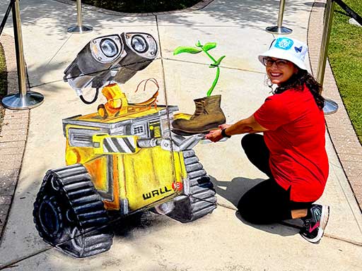 Posing with 3D chalk art of Disney Pixar's Wall-E.