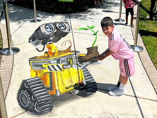 Posing with 3D chalk art of Disney Pixar's Wall-E.