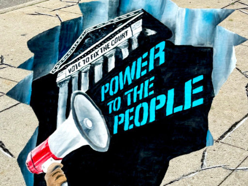 3D chalk art of a megaphone shouting Power to the People in front of a courthouse.