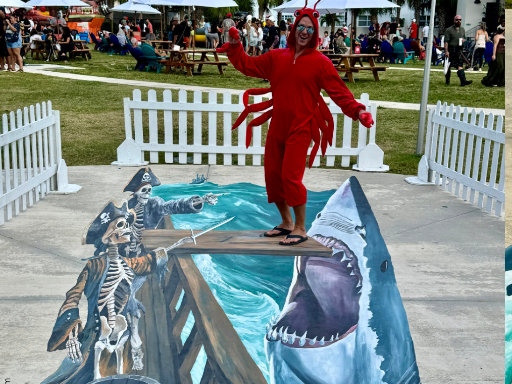 Posing with 3D painted vinyl image of a ghost ship with skeletons pointing toward the plank and a leaping shark with open mouth.