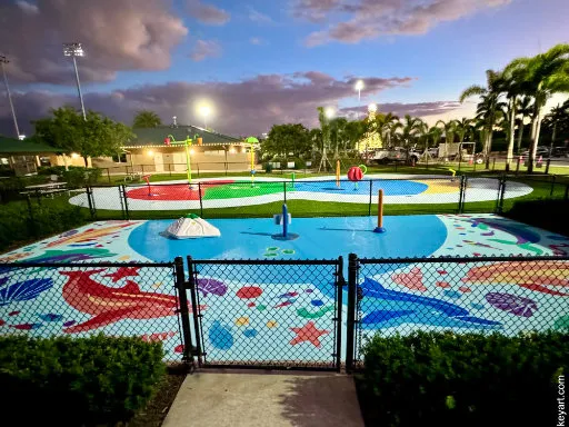 Colorful sea life mural on the ground of a childrens splash pad water playground.