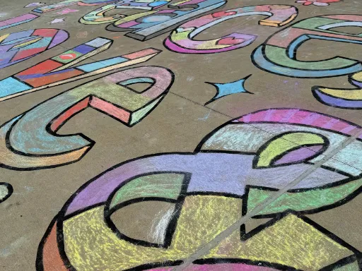 Detail of large-scale 2D coloring book doodle chalk art for kindness themed event.