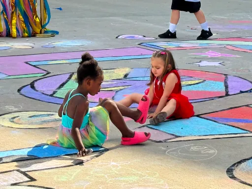 Kids coloring large-scale 2D coloring book doodle chalk art for kindness themed event.