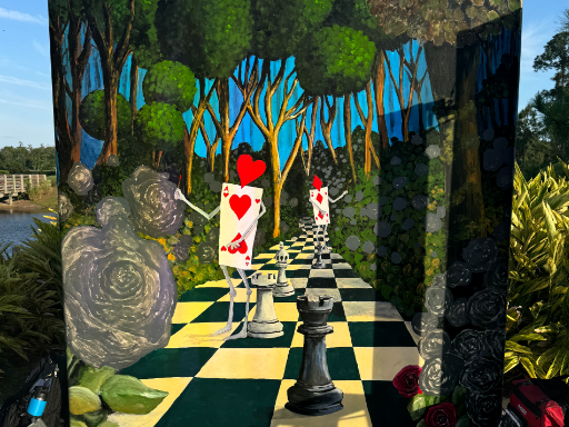 Wall mural based upon Alice and Wonderland painting the roses red.