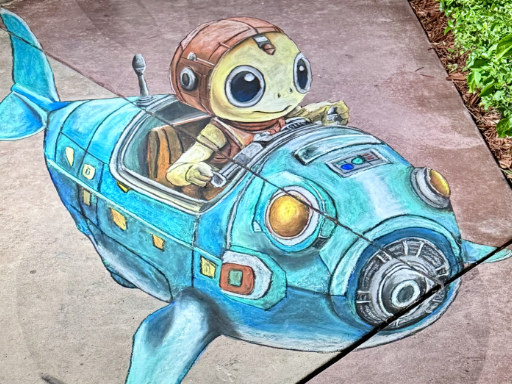 3D chalk art of an alien in a flying fish spaceship.