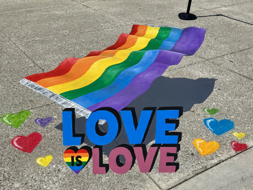 3D chalk and painted art of flying carpet Pride flag for Pride month.