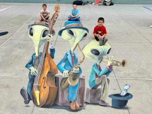 :Posing with 3D painted art of alien musicians playing jazz music.