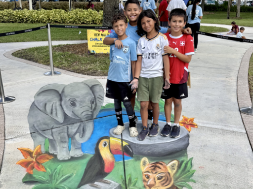 :Posing with 3D painted art of jungle animals.