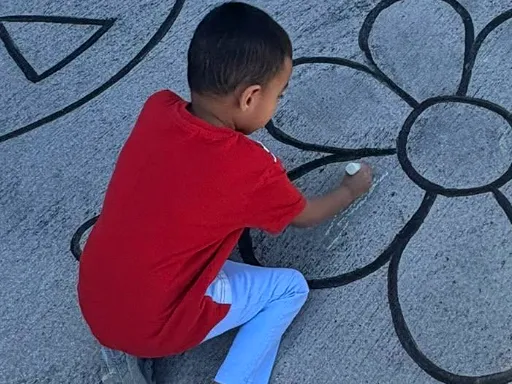 Before shot of large-scale 2D coloring book doodle chalk art for kindness themed event.