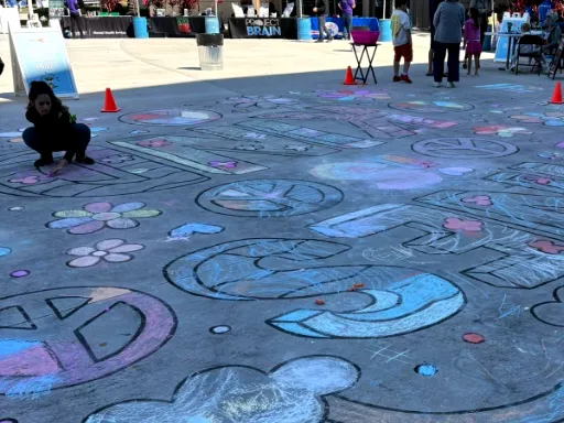 Detail of large-scale 2D coloring book doodle chalk art for kindness themed event.