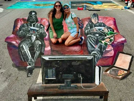 Interactive 3D painted art of Luke Skywalker and Darth Vader playing video games together on a red couch with Grogu.