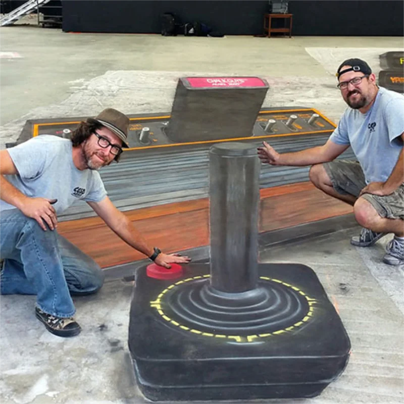 Posing with giant Atari 2600 3D chalk art.