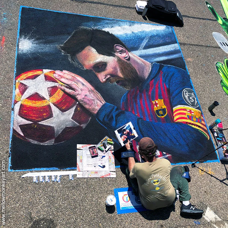 Working on chalk image of soccer player Lionel Messi.