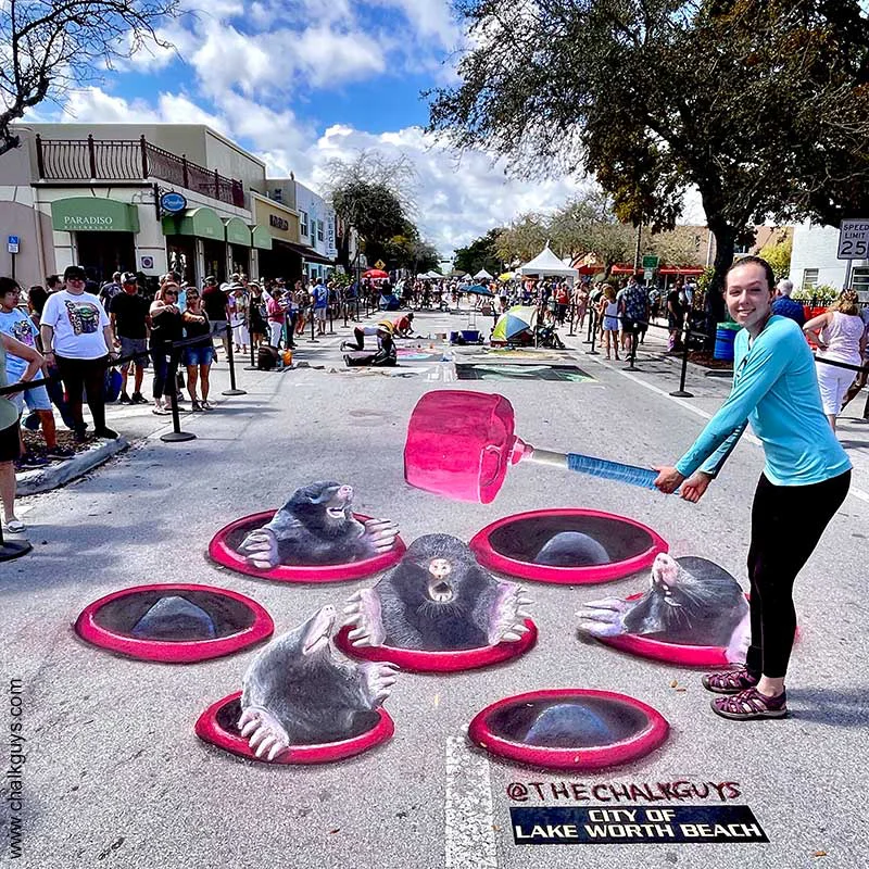 Posing with 3D chalk art interactive Whac-a-Mole.